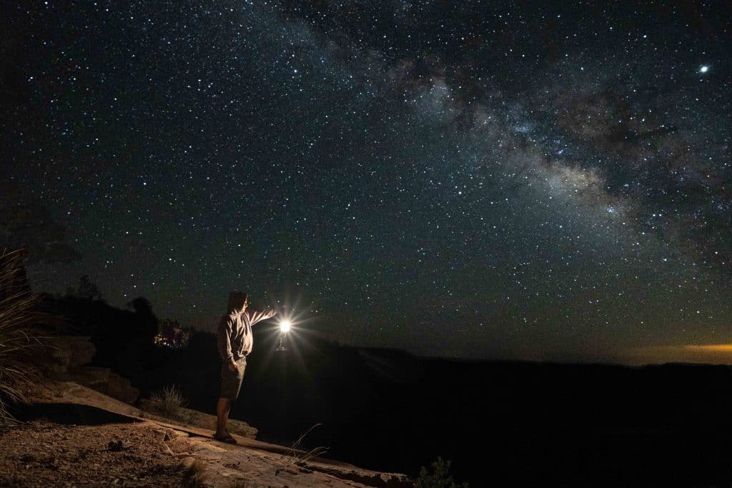 camp-light-man-dark-holding-lantern