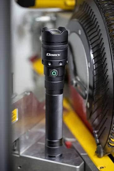 A camping torch is atop a machine.