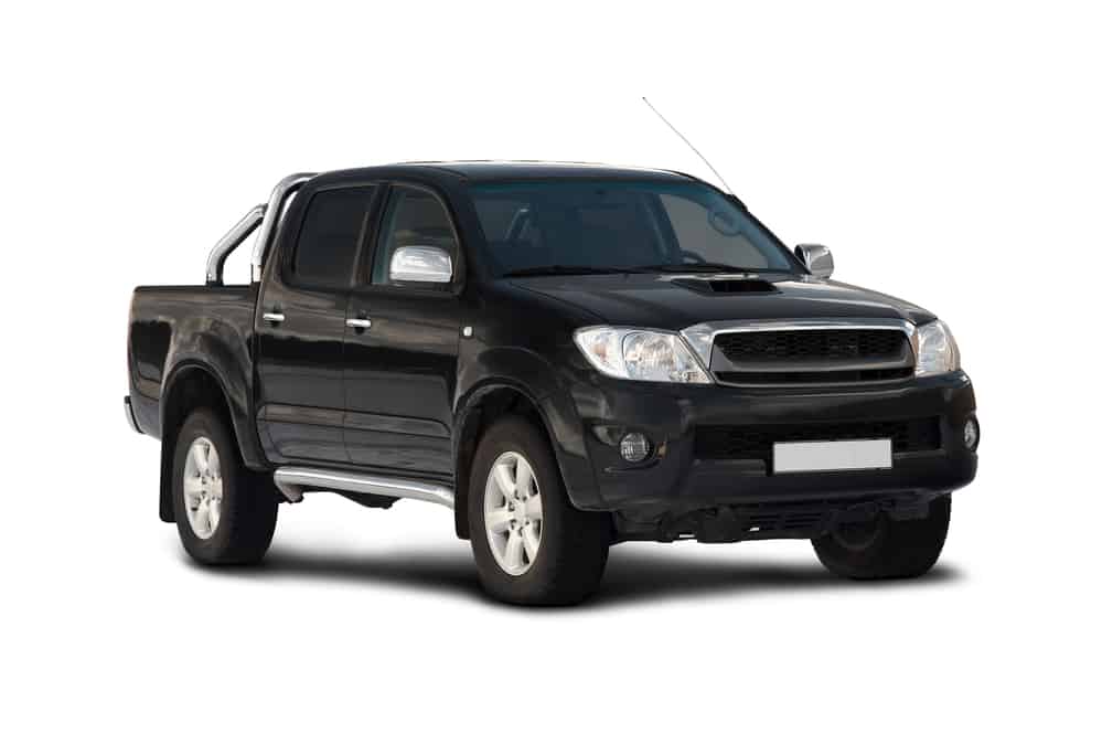A black toyota hilux ute parked on a white background.